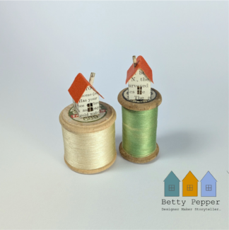 Handmade Paper House Sculptures on a vintage wooden cotton reels with various coloured threads by artist Betty Pepper.